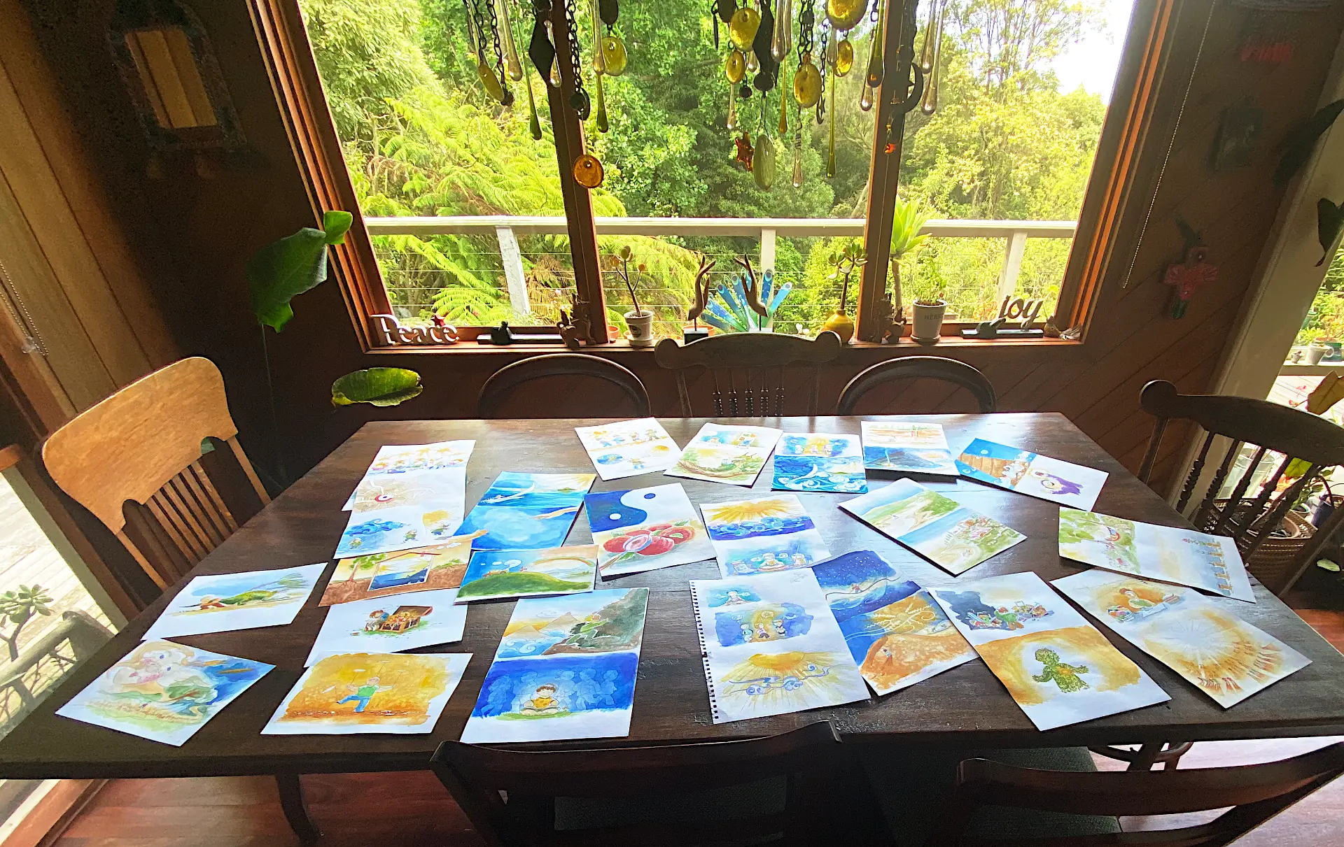 Original watercolor Keep Cool card artwork laid out on a wooden table